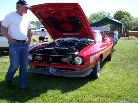 1972 Ford Ranchero - A red 1971-1973 Ford Mustang is displayed with its hood open at an outdoor event.