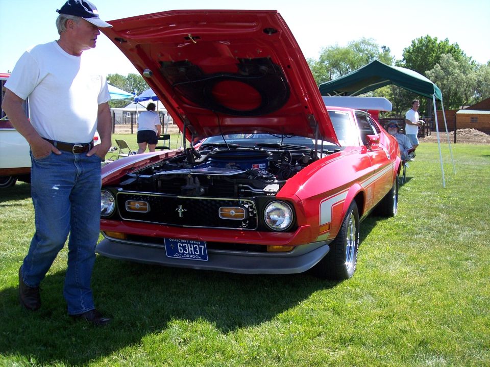 Red 1971-1973 Ford Mustang with hood open, front 3/4 view