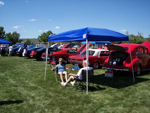 1972 Ford Ranchero - A sunny day at a car show features a variety of classic vehicles displayed on a lawn, with attendees enjoying the event.