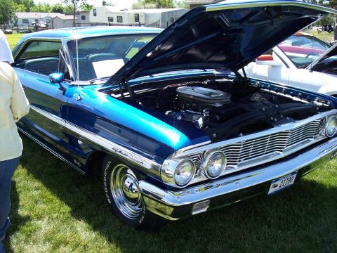 1972 Ford Ranchero - Blue 1964 Ford Galaxie 500 at a car show, hood up revealing the engine bay.
