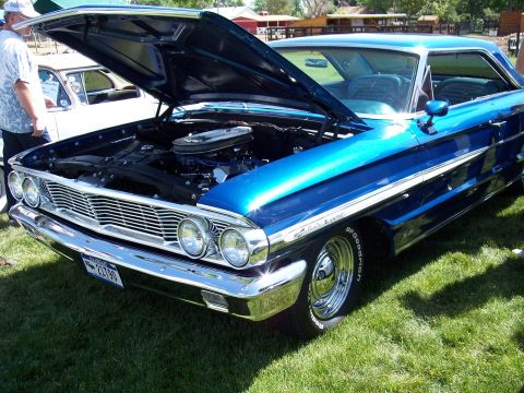 1972 Ford Ranchero - A blue 1964 Ford Galaxie 500 is displayed with its hood open on a grassy field.