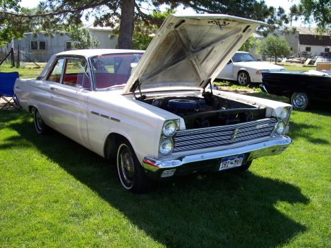 1972 Ford Ranchero - A white 1965 Mercury Comet is displayed with its hood open, parked on a grassy lawn.