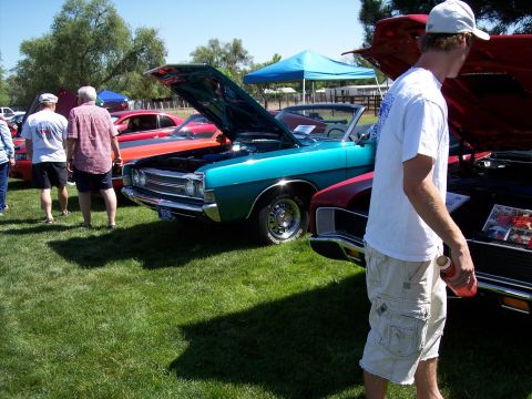 1972 Ford Ranchero - Several classic cars are on display at an outdoor event, with hoods open.