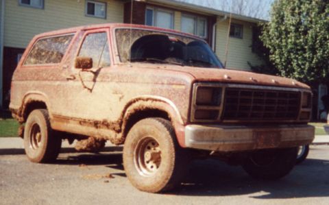 1981 Ford Bronco - This heavily muddied vehicle appears to be a Ford Bronco from the early 1980s, not specifically a 1981 model.
