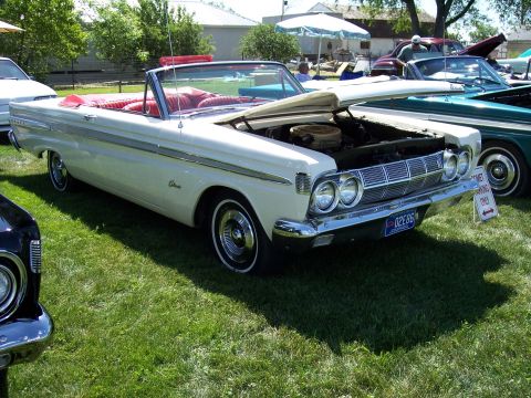 1972 Ford Ranchero - A white 1964 Mercury Comet convertible is displayed with its hood open at an outdoor event.