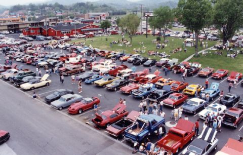 1981 Ford Bronco - A large gathering of classic cars and attendees at an outdoor event, with many vehicles on display.