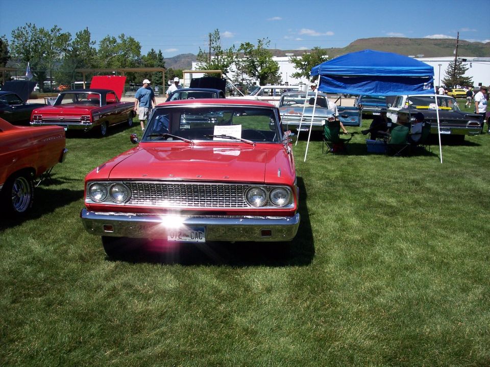 Red 1964 Ford Falcon Ranchero front view with chrome grille and dual headlights