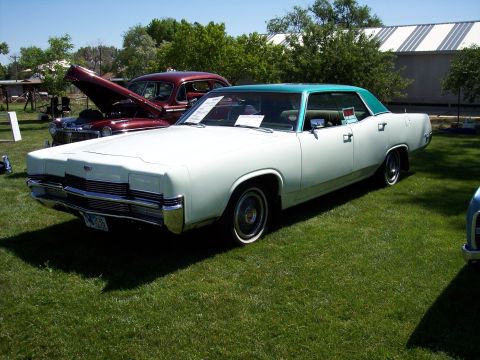 1972 Ford Ranchero - A white and teal sedan is parked on a grassy lawn, with another car visible in the background.