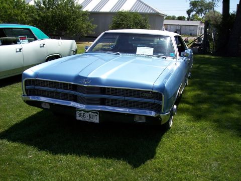 1972 Ford Ranchero - Front view of a 1968 Ford LTD sedan, parked on a grassy lawn with another vehicle nearby.