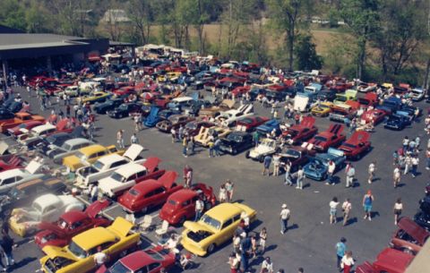 1981 Ford Bronco - A large gathering of vehicles and people at an outdoor car show event.