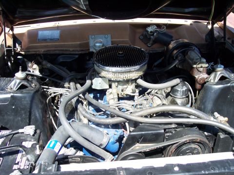 1972 Ford Ranchero - The engine bay of a vehicle is shown, a V8 engine with aftermarket modifications.