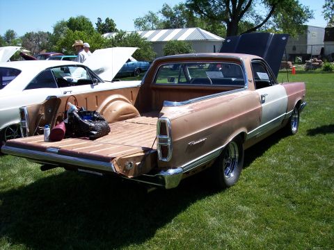 1972 Ford Ranchero - A two-tone 1972 Ford Ranchero pickup truck is parked on a grassy lawn with its hood and tailgate open.