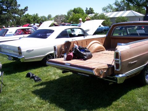 1972 Ford Ranchero - Two Ford Rancheros are parked on a grassy field at an outdoor event.