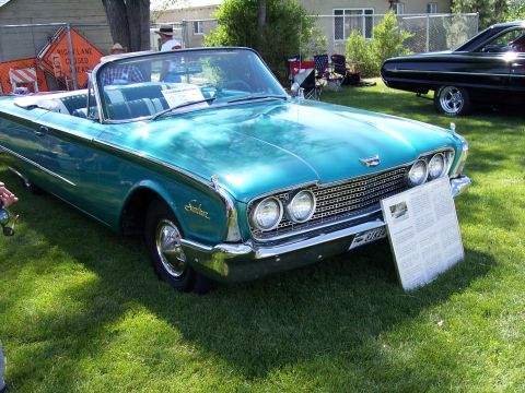 1972 Ford Ranchero - A teal 1960 Ford Falcon convertible is displayed on a grassy lawn, with a black car visible in the background.