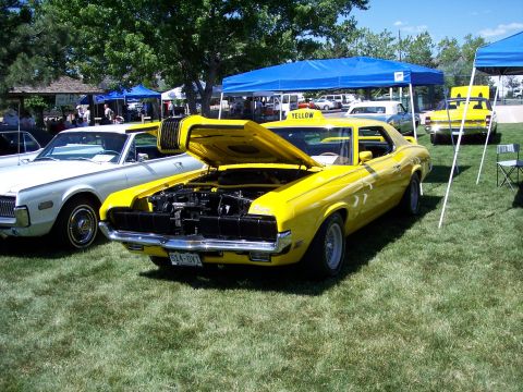1972 Ford Ranchero - Two 1970 Mercury Cougars, one yellow and one white, displayed at an outdoor event.