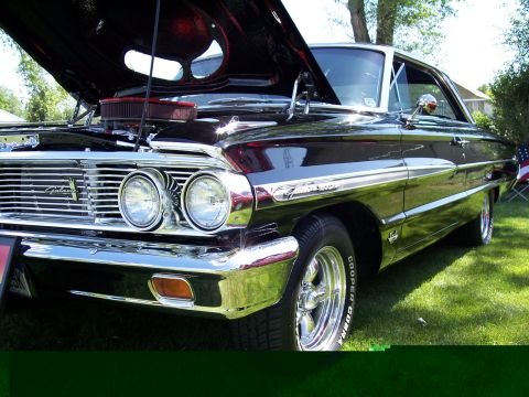 1972 Ford Ranchero - A black 1964 Ford Galaxie is displayed with its hood open, its engine and chrome details.