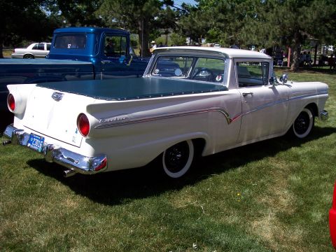 1972 Ford Ranchero - A white 1957 Ford Ranchero is parked on grass next to a blue pickup truck.