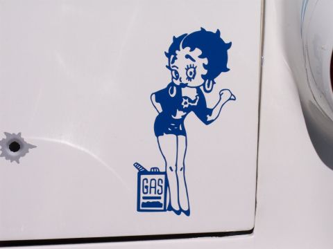 1972 Ford Ranchero - A blue decal of Betty Boop holding a gas can is applied to the side of a white vehicle.