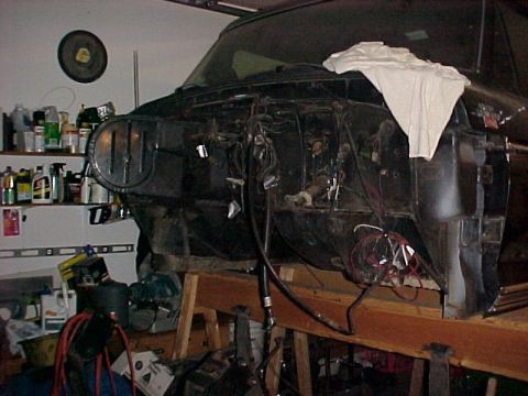 1979 Ford F-250 - The front end of a truck is disassembled, revealing the engine bay and various wires.