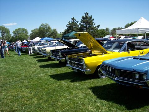 1972 Ford Ranchero - A row of vintage automobiles are displayed on a sunny day at an outdoor event.