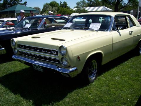 1972 Ford Ranchero - A pale yellow 1967 Ford Fairlane 500 coupe is parked on grass next to other vehicles.