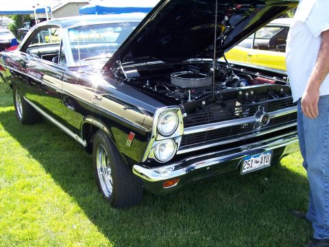 1972 Ford Ranchero - A black 1967 Ford Fairlane 500 is displayed with its hood open, revealing the engine and front grille.