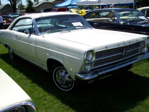 1972 Ford Ranchero - A white 1966 Ford Fairlane is displayed at an outdoor event with other vehicles present.