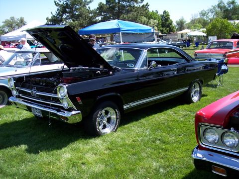 1972 Ford Ranchero - A black 1967 Ford Fairlane is displayed with its hood open at an outdoor car show.