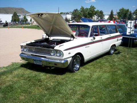 1972 Ford Ranchero - White 1961 Ford Falcon Squire wagon on display with hood up.