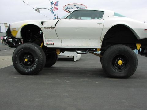 1981 Ford Bronco - This heavily modified vehicle features oversized tires and a raised suspension, significantly altering its original appearance.