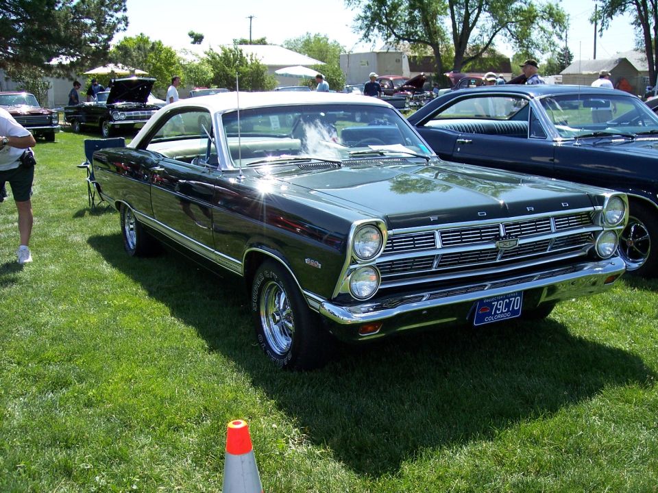 Dark green 1967 Ford Ranchero with a white roof parked on grass