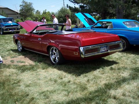 1972 Ford Ranchero - A red 1972 Ford Ranchero convertible is parked on grass next to a blue coupe.