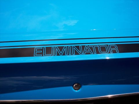 1972 Ford Ranchero - A blue vehicle features a prominent black stripe with the word "ELIMINATOR" on its side.