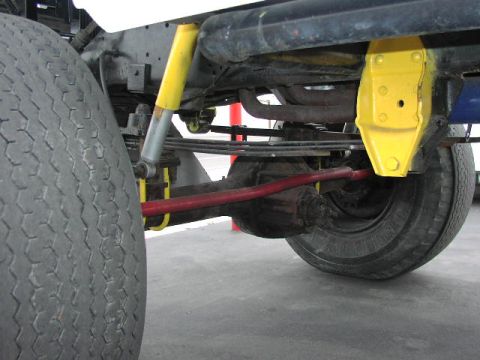 1981 Ford Bronco - Close-up view of a vehicle's suspension system, showing the rear axle and tire.