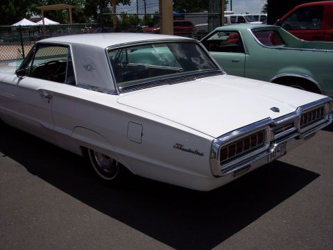 1972 Ford Ranchero - A white 1965 Ford Thunderbird is parked next to other vehicles.
