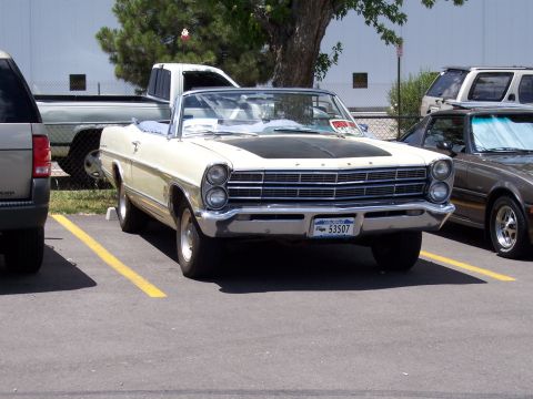 1972 Ford Ranchero - This cream-colored convertible features a black hood and distinctive quad headlights, with license plate 53507 visible.