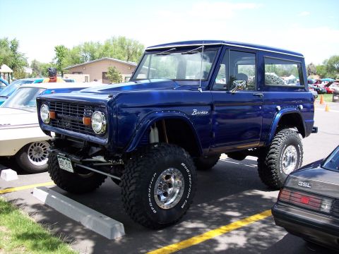1972 Ford Ranchero - This lifted blue 1972 Ford Bronco is parked at an outdoor event.
