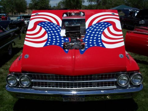 1972 Ford Ranchero - A classic car with an exposed engine and patriotic paint job sits on display at an outdoor event.