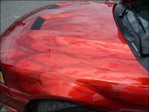 2001 Mercury Grand Marquis - A red car hood displays custom flame graphics and functional hood scoops.