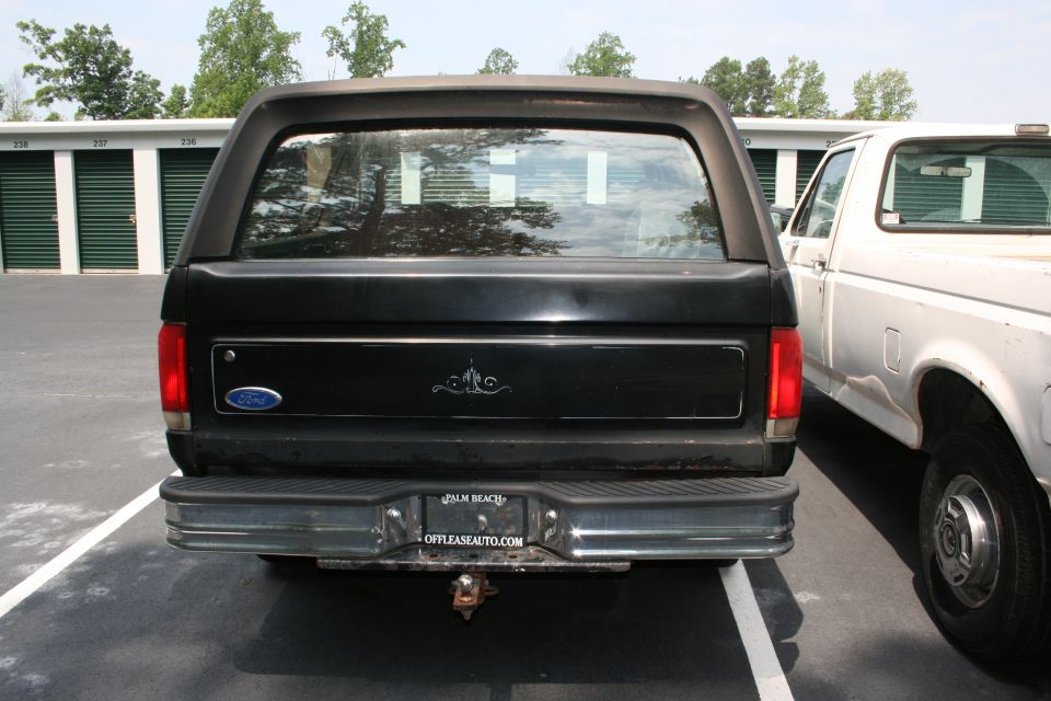 Rear view of black Ford full-size SUV in storage-unit parking lot