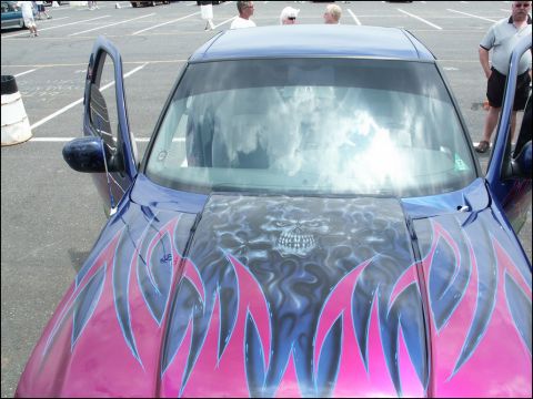 2001 Mercury Grand Marquis - A car with custom airbrushing on the hood is displayed at an outdoor event.