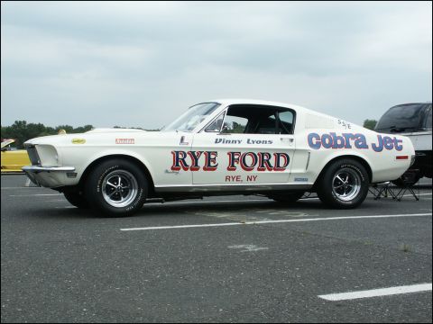 2001 Mercury Grand Marquis - Side view of a white 1967 Ford Mustang Cobra Jet race car with "Rye Ford" livery.