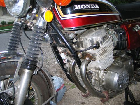 1994 Ford Bronco - Close-up of a Honda motorcycle engine and front suspension components. The "750 Four" designation is visible.