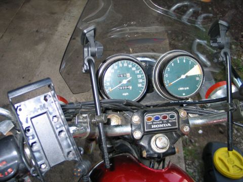 1994 Ford Bronco - Close-up of a motorcycle's dashboard, dual gauges and indicator lights for turn signals, oil, and neutral.