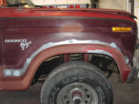 1981 Ford Bronco - Close-up of a 1981 Ford Bronco's side fender, indicating bodywork in progress.