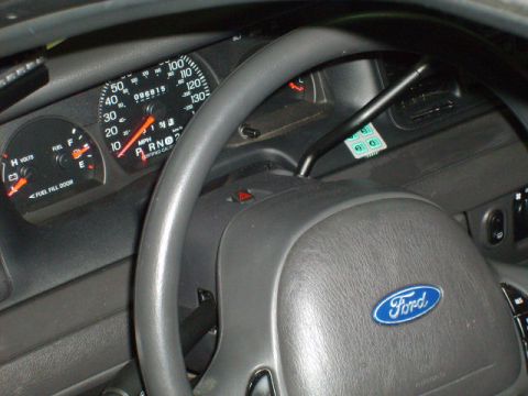 2004 Ford Crown Victoria - The interior of a 2004 Ford Crown Victoria shows the dashboard, steering wheel, and gauges.