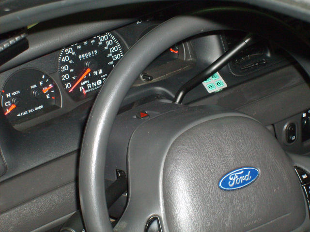 2004 Ford Crown Victoria interior dashboard with Ford logo on steering wheel