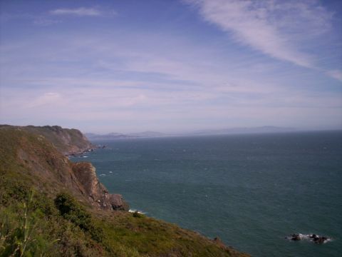 1989 Ford Bronco - A scenic view of a coastline meeting the vast ocean on a clear day.