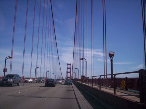 1989 Ford Bronco - View from a vehicle crossing the Golden Gate Bridge, with multiple cars on the roadway.