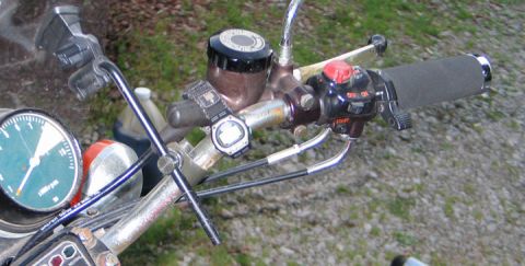 1994 Ford Bronco - Close-up view of motorcycle handlebars, showing the speedometer and various controls.
